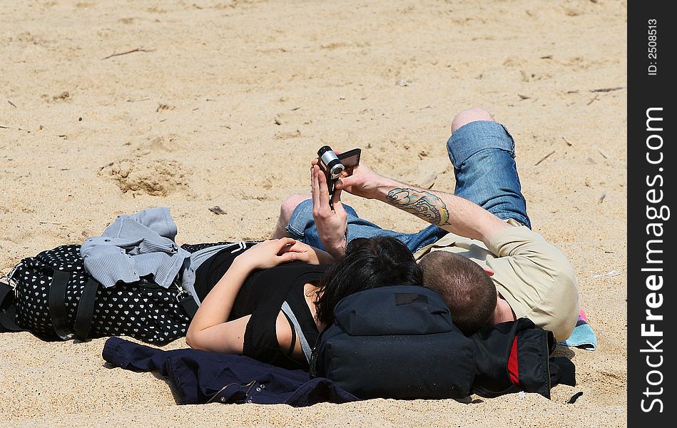 Couple with camcorder at beach