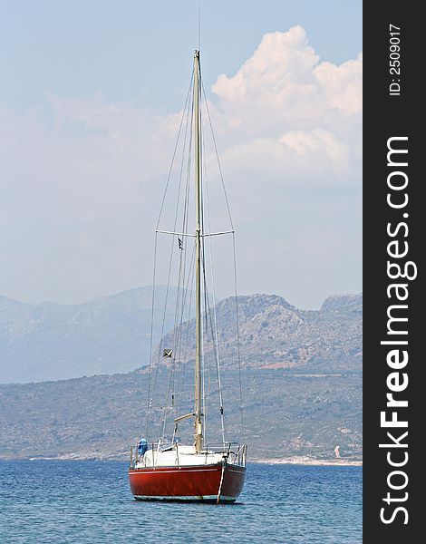 A sailing boat resting on the calm sea. A sailing boat resting on the calm sea