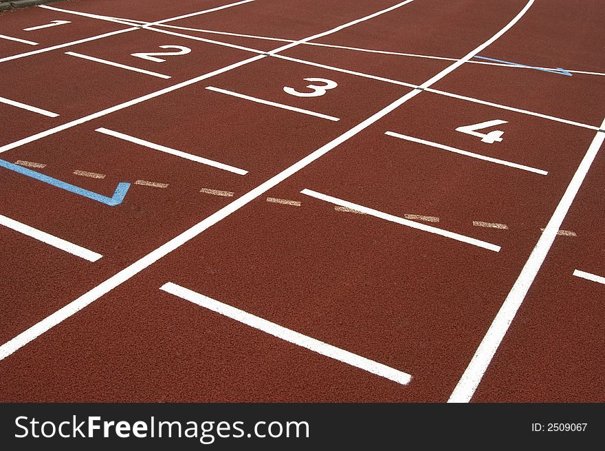 Close-up of a red en white cinder track