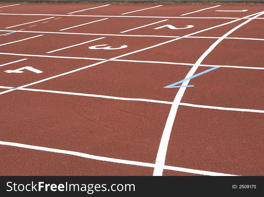 Close-up of a red en white cinder track