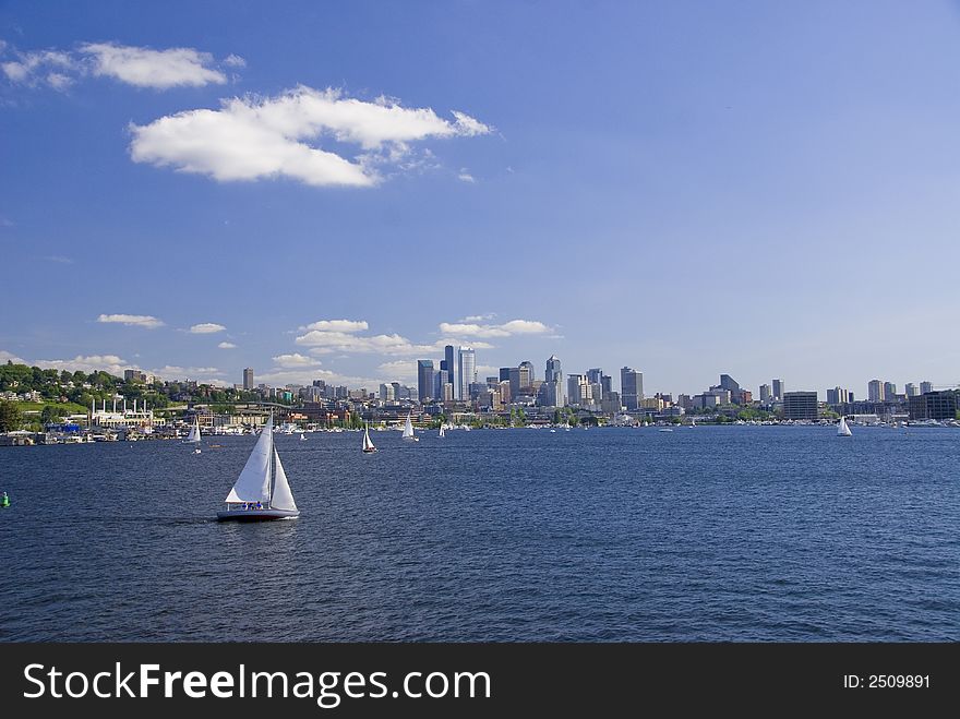 Sailboat cruising by Seattle on Lake Union. Sailboat cruising by Seattle on Lake Union