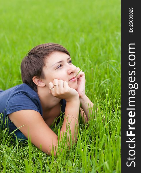 Young Woman relaxing on the green grass