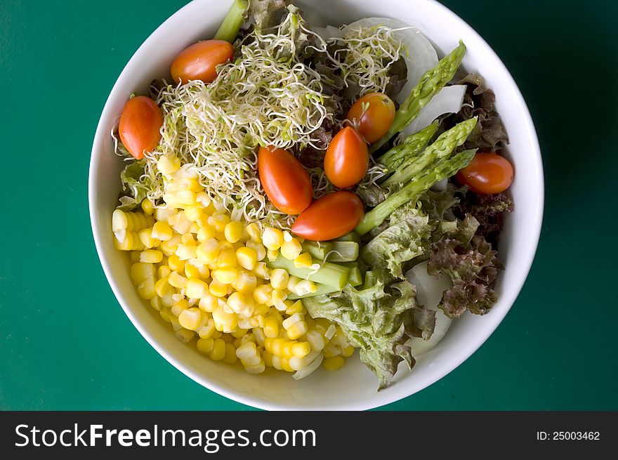 Mixed salad on green background