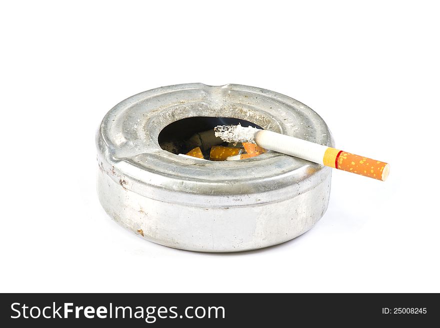Cigarette on ash tray on white background