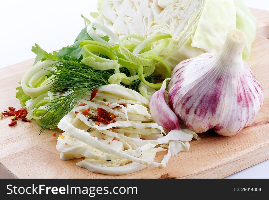 Set of cabbage and raw vegetables close up on wooden background