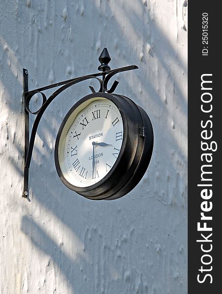 Photo of an old london paddington train station clock with roman numerals. Photo of an old london paddington train station clock with roman numerals.