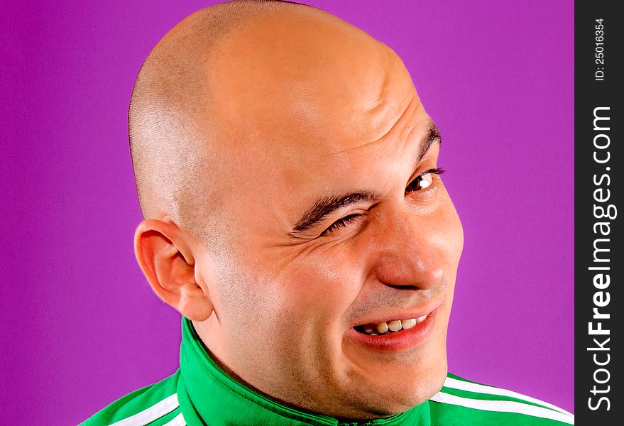 Man winking isolated on purple