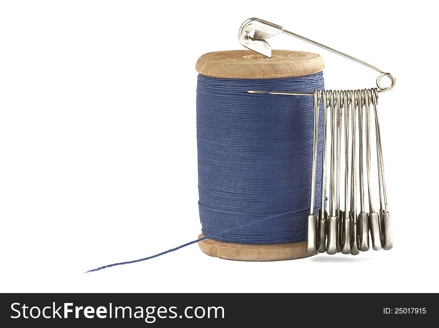 Blue thread on a spool with pins. Blue thread on a spool with pins