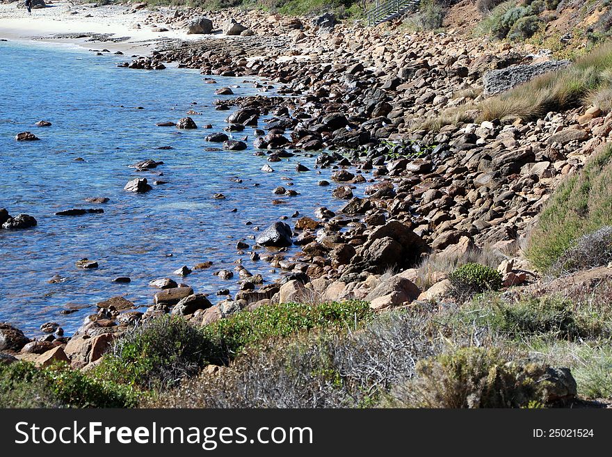 The little holiday settlement at Yallingup on the south west coast of Western Australia has ancient weathered rocky outcrops and treeless dune landscape due to the strong prevailing ocean winds. The little holiday settlement at Yallingup on the south west coast of Western Australia has ancient weathered rocky outcrops and treeless dune landscape due to the strong prevailing ocean winds.