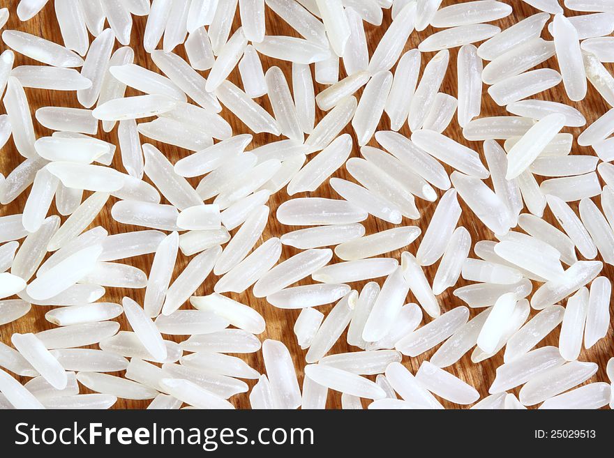 White long white rice in wooden background