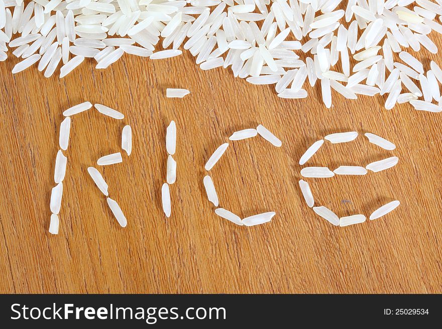 White long white rice on wooden background