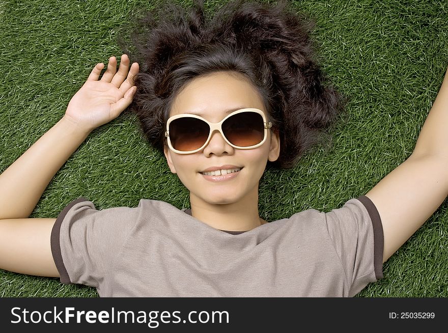 Woman laying on the green grass on the summer. Woman laying on the green grass on the summer