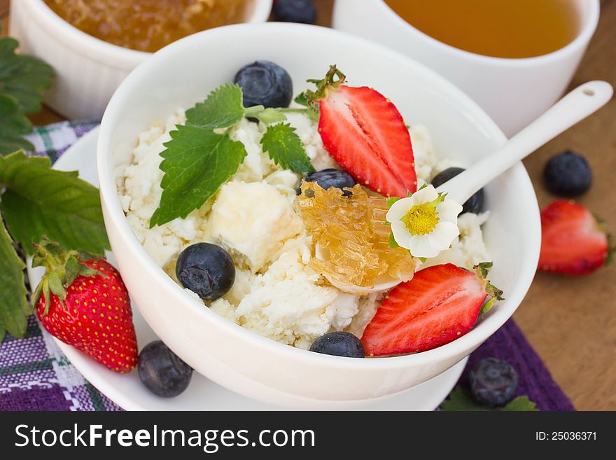 Dietary cottage cheese with honey, blueberries and strawberry. Dietary cottage cheese with honey, blueberries and strawberry