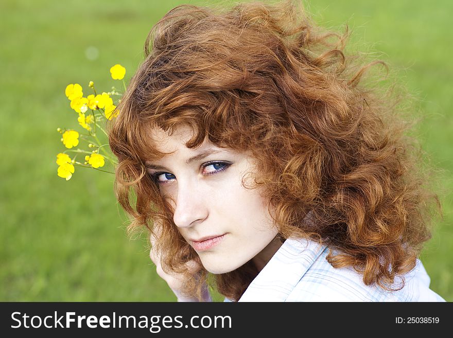 Summer image of cute young woman with flower, close up