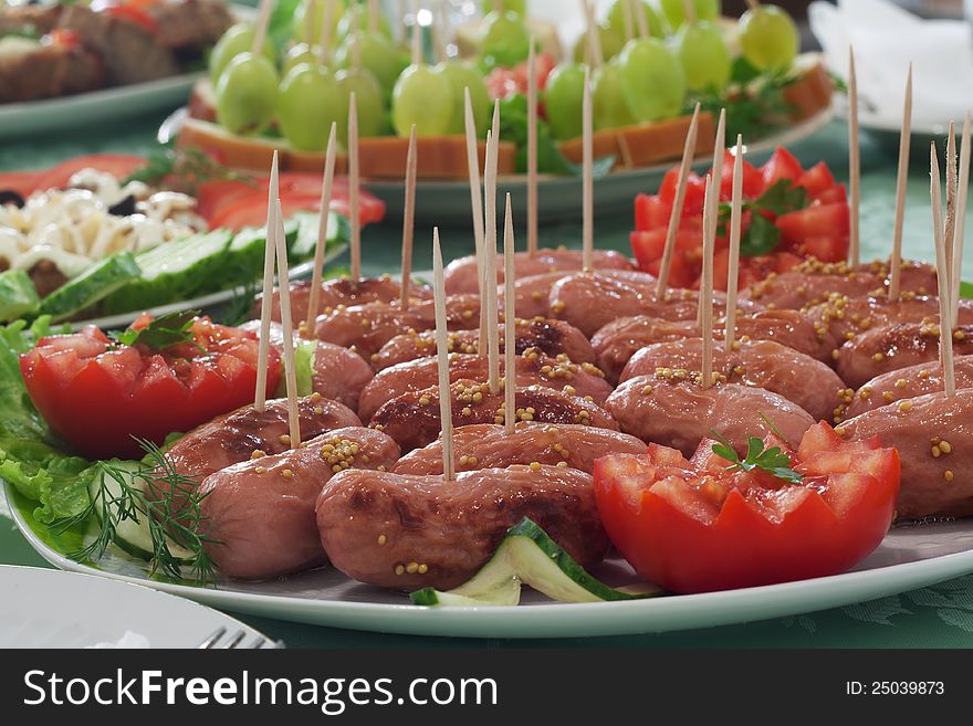 Buffet table. Frankfurters, tomatoes and other delicious food.