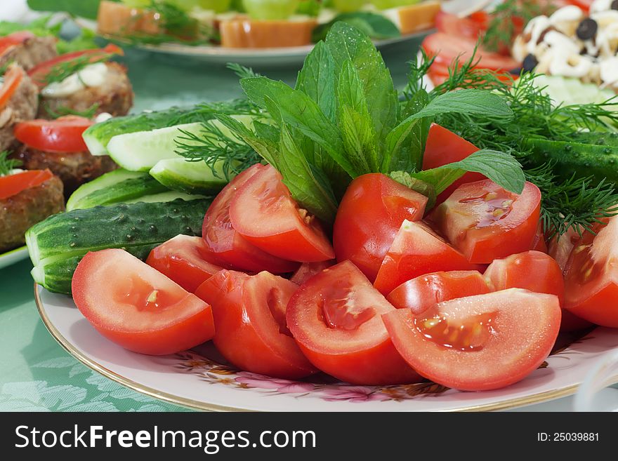 Tomatoes and cucumber on plate. Tomatoes and cucumber on plate.