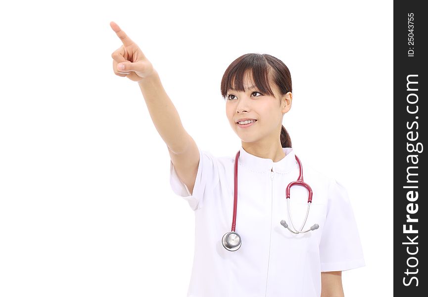 Portrait of happy young asian female nurse pointing