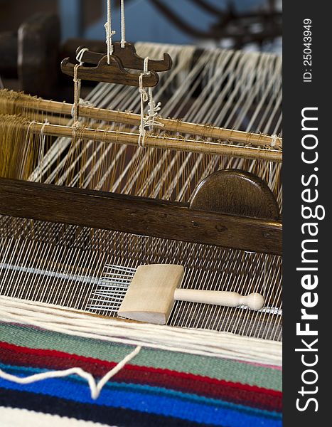 Manual loom with a rug being made