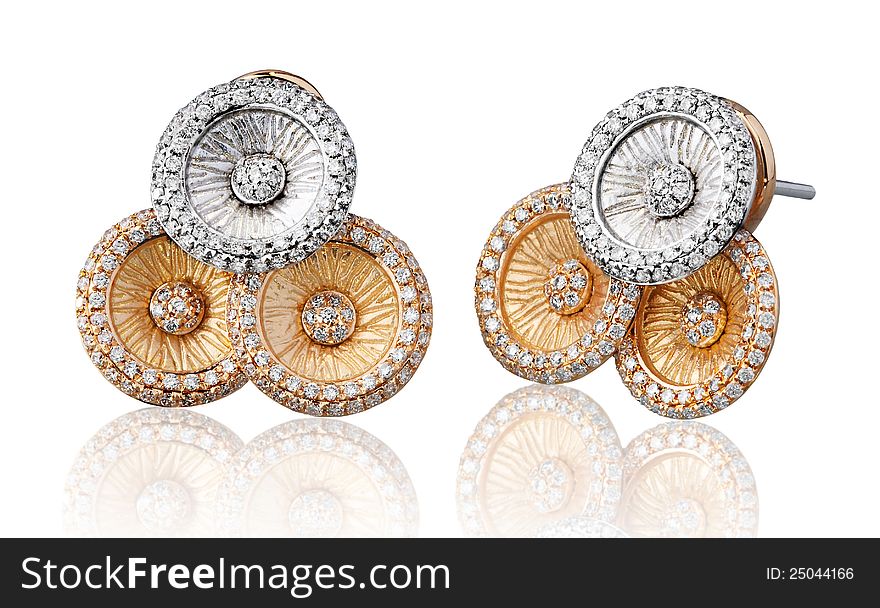 Silver and gold earrings decorated by diamonds