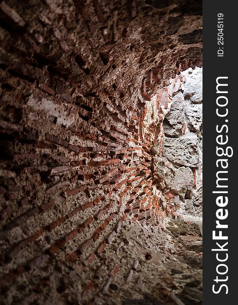 Vertical Photo of a spherical shaped stone corridor. There is light at the end of the corridor. Vertical Photo of a spherical shaped stone corridor. There is light at the end of the corridor.