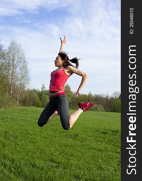 Active woman jumping in the park, outside sport shot. Active woman jumping in the park, outside sport shot