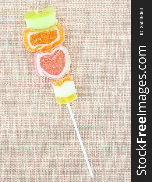 Colorful jelly candy stick on fabric