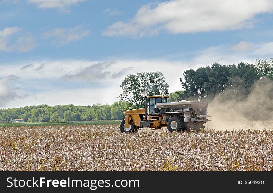 Vehicle spreading lime onto a farm field