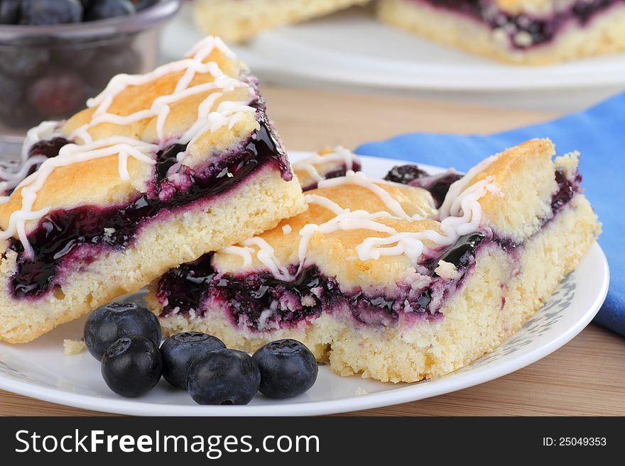 Closeup of two blueberry bars with berries on a plate. Closeup of two blueberry bars with berries on a plate