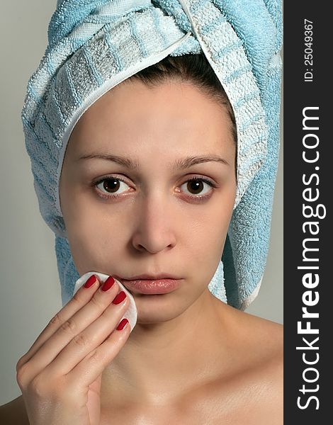 Close up of pretty woman removing makeup with cotton pad - skin care concept. Close up of pretty woman removing makeup with cotton pad - skin care concept.