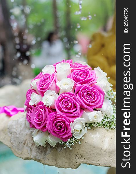 Flowers roses wedding bouquet in fountain sprays water droplets