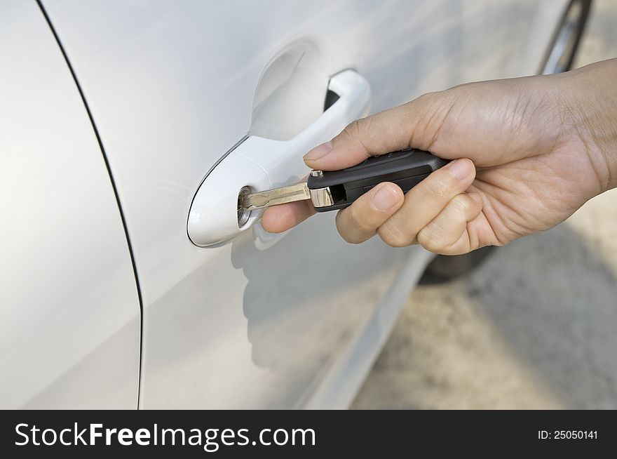 Woman hand inserting key to her new car. Woman hand inserting key to her new car