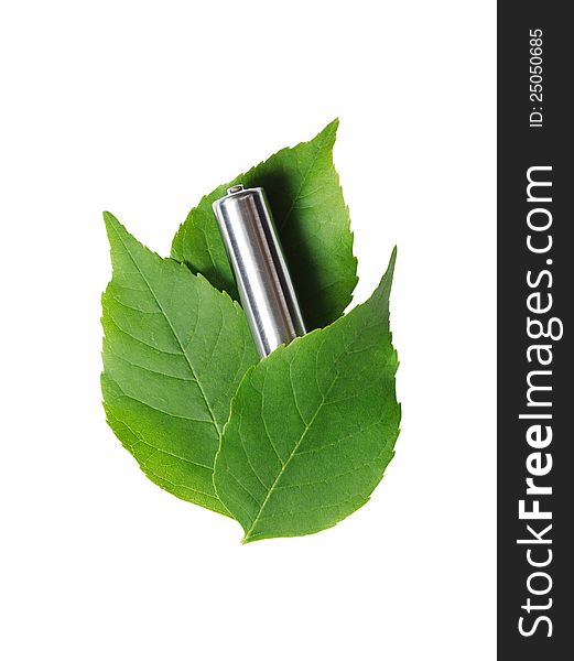 Ecology concept. Ordinary used battery lying on green leaves. Isolated on white with clipping path. Ecology concept. Ordinary used battery lying on green leaves. Isolated on white with clipping path