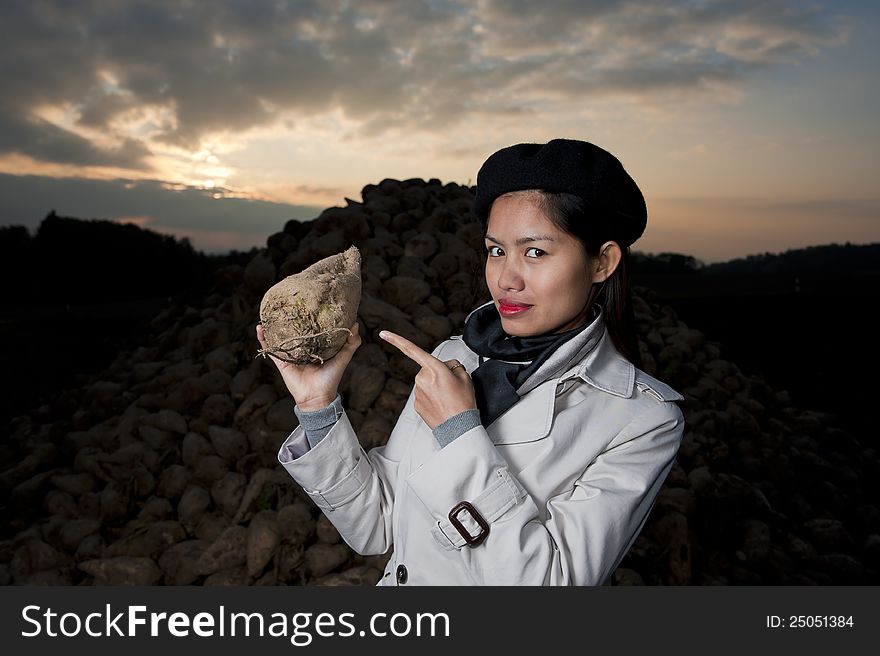 Pretty woman with sugar beet in her hand. Pretty woman with sugar beet in her hand