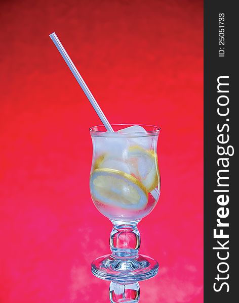 Cold fresh with ice lemonade  on  red background. Cold fresh with ice lemonade  on  red background