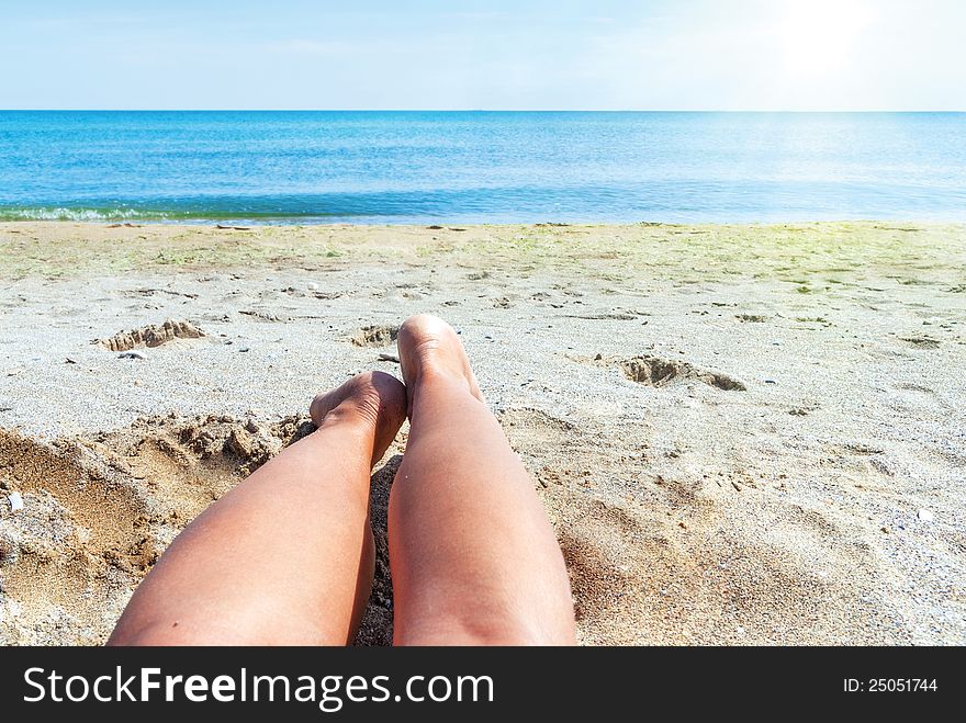 Wet female feet on the beach , sand and sun. Wet female feet on the beach , sand and sun