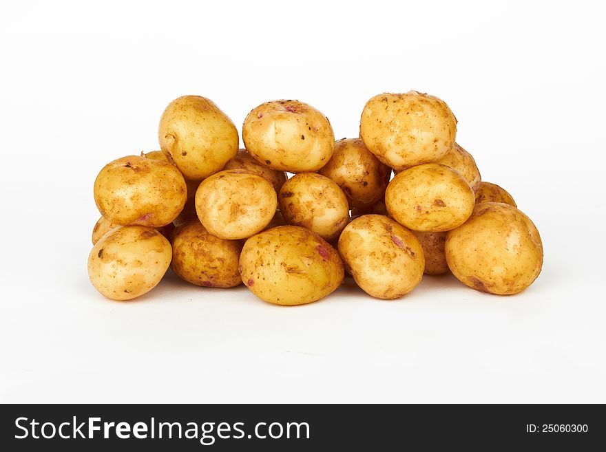 Bunch of potatoes on white background close up shoot