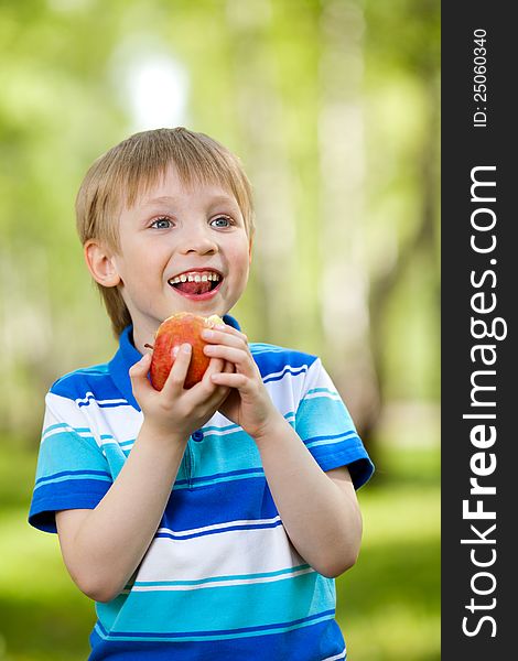 Kid eating healthy food apple outdoor. Kid eating healthy food apple outdoor