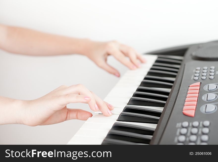 Hands of girl playing on electronic piano. Hands of girl playing on electronic piano