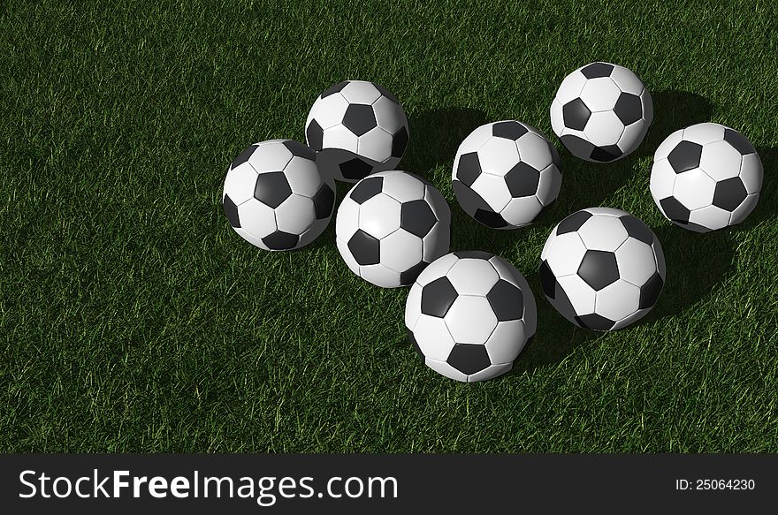 Football or soccer balls on a green lawn