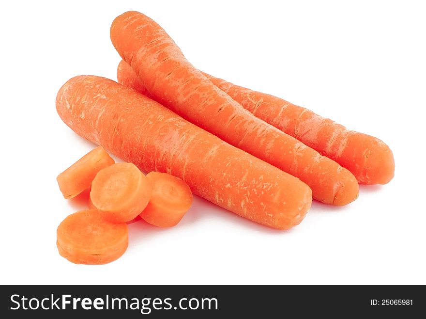 Three carrots and slices on white background