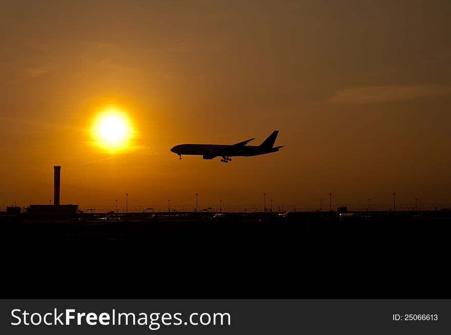 Airplane landing in sunset sky. Airplane landing in sunset sky