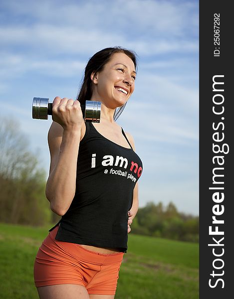 Woman working with dumbbell