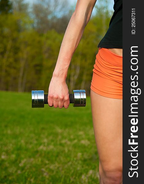 Woman working with dumbbell, sport theme shot