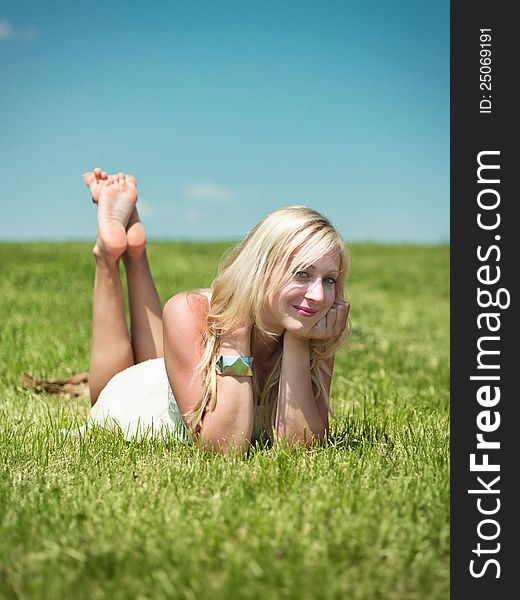 Nice day in nature. young woman on a grass field looking into camera