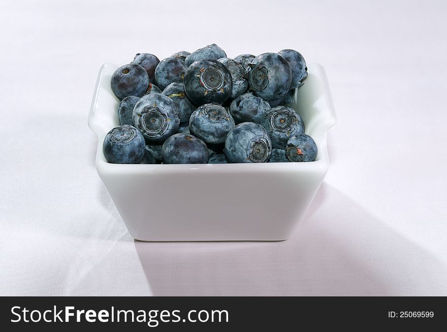 Blueberries in small white bowl. Blueberries in small white bowl