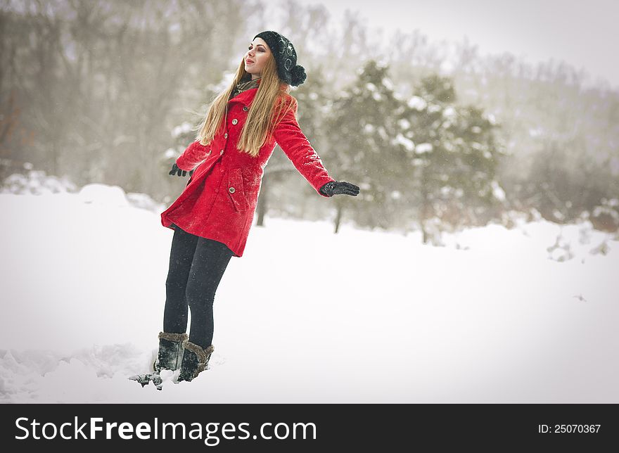 Happy Girl With Cap And Gloves Playing With Snow