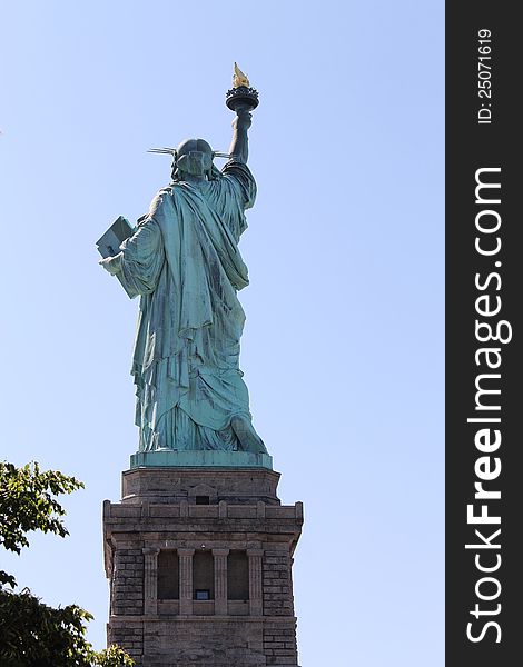 Statue of Liberty on Liberty island as seen from behind showing details of the back. Statue of Liberty on Liberty island as seen from behind showing details of the back