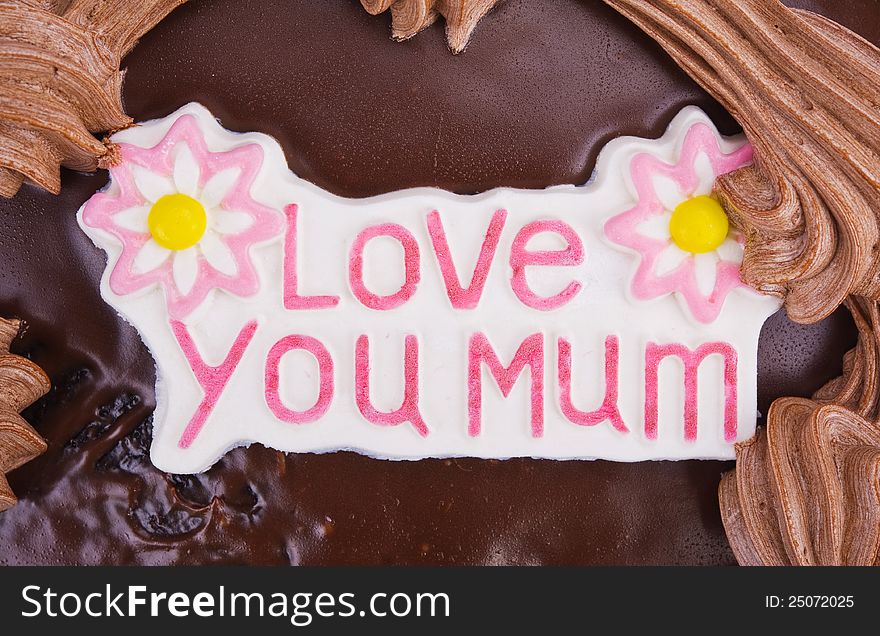 Fragment of dark chocolate cake with text