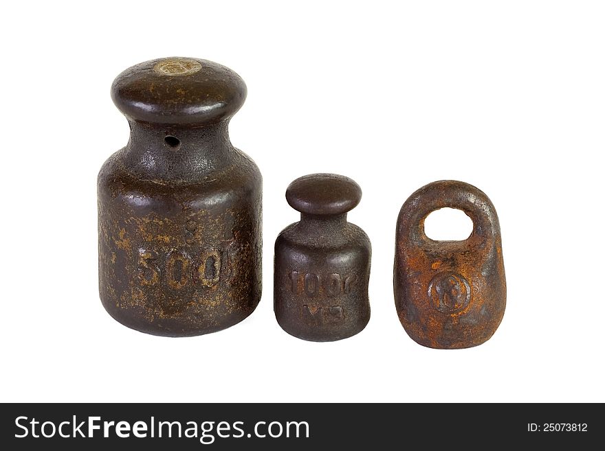 Three of the old weights for scales on a white background