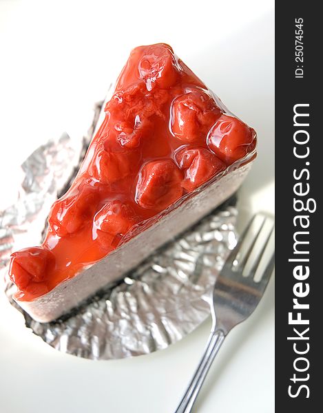 Cherry cheesecake on white plate view on top. Cherry cheesecake on white plate view on top